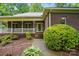 Charming brick home with a covered porch and well-manicured landscaping at 7725 Whitmire Ln, Mint Hill, NC 28227