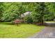 Well-maintained front yard and covered porch offer curb appeal to this charming home at 7725 Whitmire Ln, Mint Hill, NC 28227