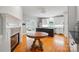 Open kitchen with a fireplace and an island with a cooktop at 7725 Whitmire Ln, Mint Hill, NC 28227