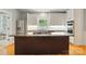Bright kitchen features a center island with granite countertop, stainless steel appliances, and plenty of cabinet space at 7725 Whitmire Ln, Mint Hill, NC 28227