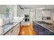 Well-lit kitchen featuring white cabinets, stainless steel appliances, and granite countertops at 7725 Whitmire Ln, Mint Hill, NC 28227
