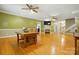 Open concept living room boasts hardwood floors, fireplace, and staircase at 7725 Whitmire Ln, Mint Hill, NC 28227