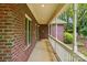 A covered porch with brick columns offers a relaxing outdoor space at 7725 Whitmire Ln, Mint Hill, NC 28227