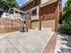 Brick home featuring backyard, two-car garage, basketball hoop, and partial fence at 8218 Houston Ridge Rd, Charlotte, NC 28277