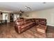 Finished basement featuring a leather sectional sofa, wood flooring, and bar area at 8218 Houston Ridge Rd, Charlotte, NC 28277