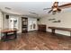 Finished basement featuring a bar area, wood flooring, and exterior access via french doors at 8218 Houston Ridge Rd, Charlotte, NC 28277