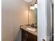 Bathroom featuring a vanity with granite countertop, dark wood cabinetry, and modern fixtures at 8218 Houston Ridge Rd, Charlotte, NC 28277