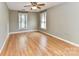 A spacious bedroom features hardwood floors, light gray walls, and a ceiling fan at 8218 Houston Ridge Rd, Charlotte, NC 28277