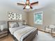 Comfortable bedroom with a ceiling fan and ample natural light from a window at 8218 Houston Ridge Rd, Charlotte, NC 28277
