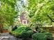 Charming brick home featuring lush landscaping and a welcoming front entrance with a brick walkway at 8218 Houston Ridge Rd, Charlotte, NC 28277