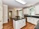 Spacious kitchen with white cabinets, granite countertops, an island, and hardwood floors at 8218 Houston Ridge Rd, Charlotte, NC 28277