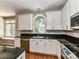 Well-lit kitchen features granite countertops, modern white cabinets, and stainless steel appliances at 8218 Houston Ridge Rd, Charlotte, NC 28277