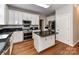 Well-appointed kitchen with an island, granite countertops, stainless steel appliances, and white cabinetry at 8218 Houston Ridge Rd, Charlotte, NC 28277
