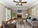 Cozy living room features a fireplace, large windows, neutral tones and comfortable seating at 8218 Houston Ridge Rd, Charlotte, NC 28277
