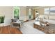 Bright and airy living room with large windows, hardwood floors, and comfortable contemporary furnishings at 8218 Houston Ridge Rd, Charlotte, NC 28277