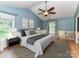 Spacious main bedroom with hardwood floors, ceiling fan, and ample natural light at 8218 Houston Ridge Rd, Charlotte, NC 28277