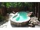 Backyard pool featuring stone accents, surrounding patio, and access to adjacent lounge seating at 8218 Houston Ridge Rd, Charlotte, NC 28277