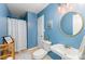 Bright blue bathroom featuring a vanity, toilet, and a shower with a white curtain at 8624 Canter Post Dr, Charlotte, NC 28216