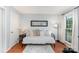 Bedroom with hardwood floors, a mirror, and a window providing natural light at 8624 Canter Post Dr, Charlotte, NC 28216