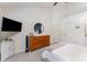 Bright bedroom with white walls, vaulted ceilings, dresser, and mounted TV at 8624 Canter Post Dr, Charlotte, NC 28216