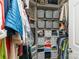 Organized walk-in closet with shelves, storage bins, and hanging clothes at 8624 Canter Post Dr, Charlotte, NC 28216