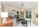 Open-concept dining area with black chairs and a view of the living room at 8624 Canter Post Dr, Charlotte, NC 28216