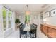 Dining room with a modern chandelier, neutral walls, large windows, and elegant decor at 8624 Canter Post Dr, Charlotte, NC 28216