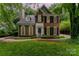 Charming brick home with black shutters and lush green lawn at 8624 Canter Post Dr, Charlotte, NC 28216