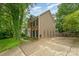 Spacious home exterior featuring a large driveway, mature landscaping, and neutral siding at 8624 Canter Post Dr, Charlotte, NC 28216