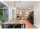 Open kitchen with wood cabinets, stainless steel appliances, a window, and adjacent dining area at 8624 Canter Post Dr, Charlotte, NC 28216