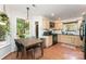 Bright kitchen with wood cabinets and stainless steel appliances, adjacent to dining area and backyard view at 8624 Canter Post Dr, Charlotte, NC 28216