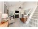 Bright living room with fireplace, ceiling fan, and staircase at 8624 Canter Post Dr, Charlotte, NC 28216