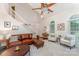 Bright living room with vaulted ceiling, staircase, neutral colors, and comfortable leather seating at 8624 Canter Post Dr, Charlotte, NC 28216