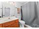 Traditional bathroom with a cherry vanity, neutral walls, and a combined tub and shower at 945 Heritage Pkwy, Fort Mill, SC 29715