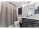 A clean bathroom featuring a vanity with marble countertop and a shower with gray curtains at 945 Heritage Pkwy, Fort Mill, SC 29715