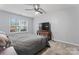 This bedroom features a gray quilt bed, a ceiling fan, and a bright window at 945 Heritage Pkwy, Fort Mill, SC 29715