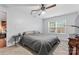 This bedroom features a gray quilt bed, a ceiling fan, and a bright window at 945 Heritage Pkwy, Fort Mill, SC 29715