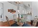 Open dining area features modern lighting, glass table, and easy access to other living spaces at 945 Heritage Pkwy, Fort Mill, SC 29715
