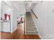 Spacious entryway with wood flooring leading to carpeted stairs and a view of the living area at 945 Heritage Pkwy, Fort Mill, SC 29715