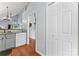 Hallway with view of kitchen provides access to additional storage and staircase at 945 Heritage Pkwy, Fort Mill, SC 29715