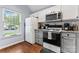 Bright kitchen featuring white cabinets, granite countertops, and stainless steel appliances at 945 Heritage Pkwy, Fort Mill, SC 29715