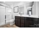Modern bathroom featuring double vanities and a glass-enclosed shower, providing a sleek and functional space at 10124 Florentine Way, Charlotte, NC 28214