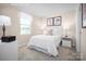 Bright bedroom with a cozy queen bed, a window with white drapes and coordinated decor, creating a peaceful retreat at 10124 Florentine Way, Charlotte, NC 28214