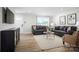 Well-lit living room includes a plush sofa, modern decor, and a cozy atmosphere at 10124 Florentine Way, Charlotte, NC 28214