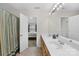 The bathroom features double sinks, a large mirror, a curtained shower, and an entry to the bedroom at 1023 Valley Ridge Rd, Charlotte, NC 28214