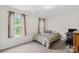 This bedroom features a bed, desk with computer, neutral walls, and a window with curtains at 1023 Valley Ridge Rd, Charlotte, NC 28214