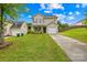 Charming two-story home featuring a well-maintained lawn, attached garage, and inviting front porch area at 1023 Valley Ridge Rd, Charlotte, NC 28214