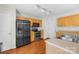 Well-lit kitchen with stainless steel appliances, wood cabinets, and easy access to an outdoor area at 1023 Valley Ridge Rd, Charlotte, NC 28214