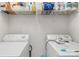 This laundry room has a washer and dryer with a wire shelf for storage at 1023 Valley Ridge Rd, Charlotte, NC 28214