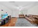 Spacious living room featuring hardwood floors, a ceiling fan, and ample natural light from a window at 1023 Valley Ridge Rd, Charlotte, NC 28214